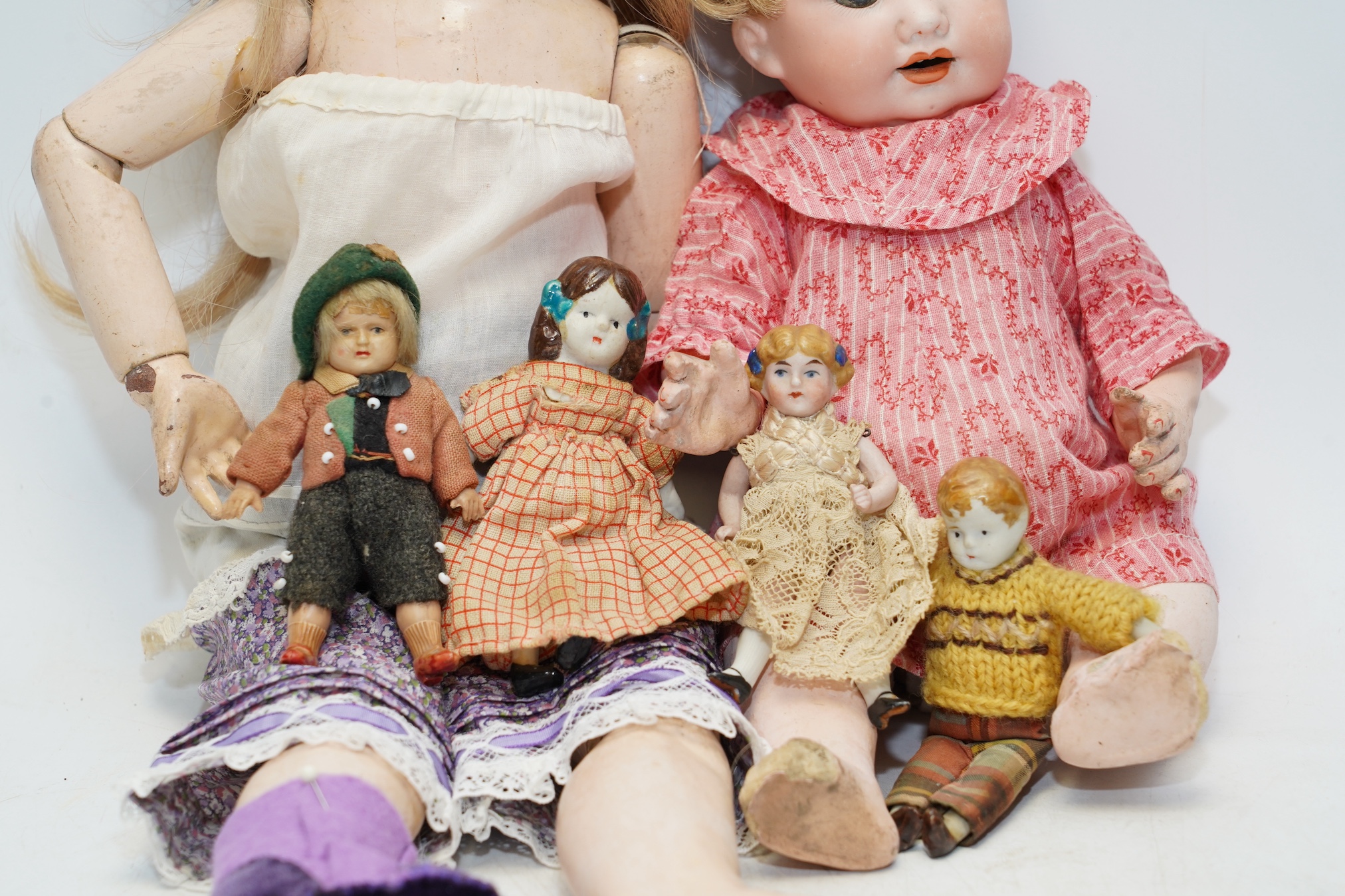 An AM bisque headed doll, an SFBJ 60 bisque doll and four miniature dolls. Condition - poor to fair